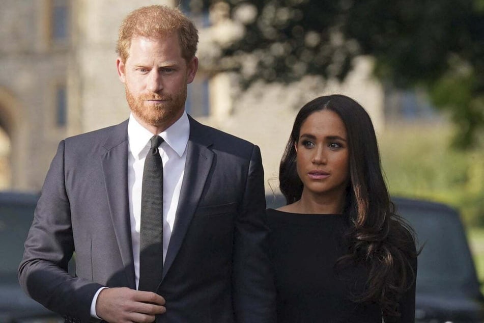 Prince Harry (l.) and Meghan Markle have sparked rumors of financial struggles, as the couple recently laid off several of their employees.