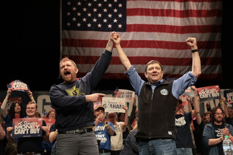 Senate candidate Graham Platner (l.) and gubernatorial candidate Troy Jackson (r.) stand together during a “Fighting Oligarchy” tour stop on the University of Maine campus in Orono on May 24, 2026.