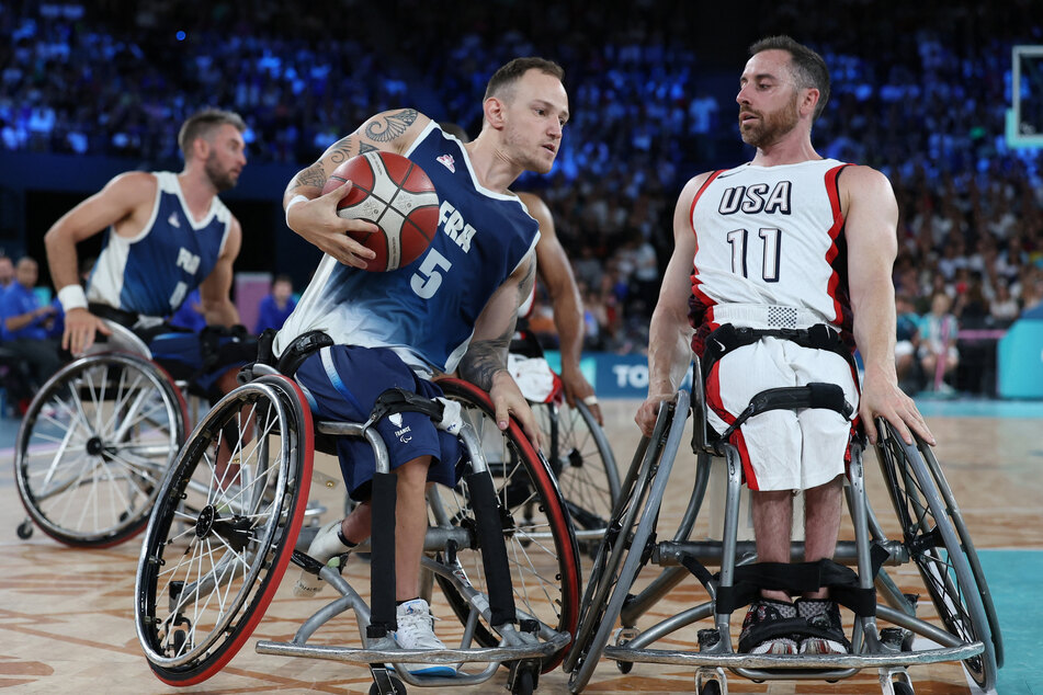 Steve Serio of Team USA in action against Alexis Ramonet of France during the wheelchair basketball men's quarter-final at the Paris Paralympics.