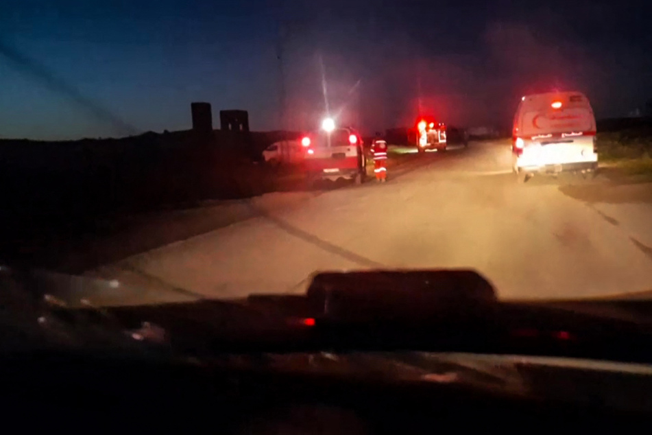 Ambulances with their emergency lights flashing are seen in an image grab from a video reportedly recovered from the cellphone of an aid worker killed in Gaza alongside other rescuers.