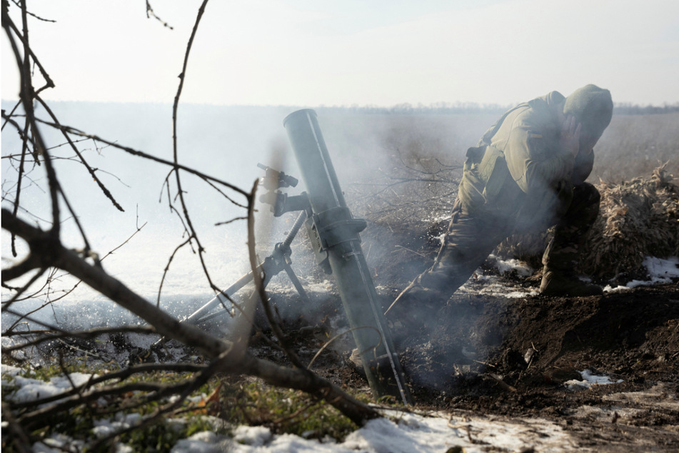 A Ukrainian fighter fires towards Russian troops in the Donetsk region of Ukraine amid Russia's heightened attacks on the country.
