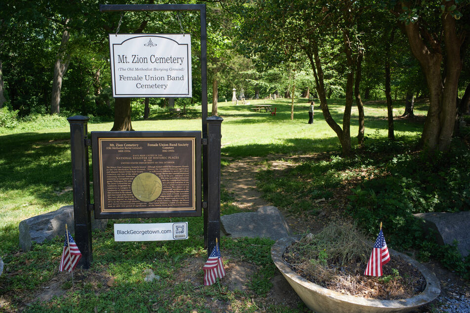 Signs outside of the Mount Zion Cemetery/Female Union Band Society Cemetery are seen in the Georgetown neighborhood of Washington DC on May 10, 2026.