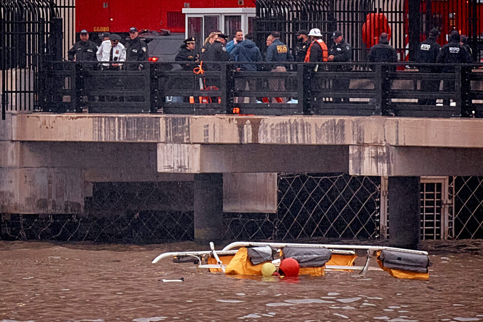 Police and firefighters work on the site after a helicopter crashed in the Hudson River on Thursday in Jersey City, New Jersey.
