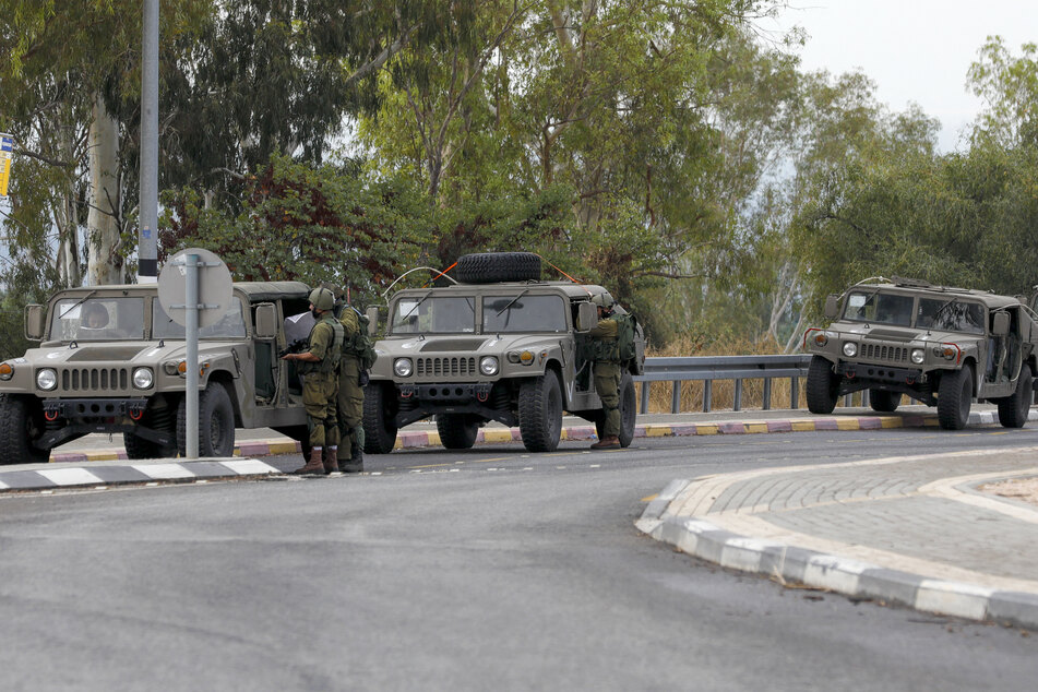 Israeli soldiers take positions near the Israeli military base of Har Dov on Mount Hermon, a strategic and fortified outpost at the crossroads between Israel, Lebanon, and Syria, on October 10, 2023.