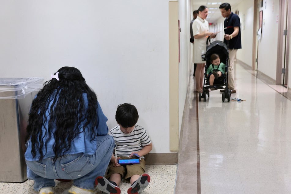 Children wait outside of an immigration court at the Jacob K. Javits Federal Building in New York on July 31. 