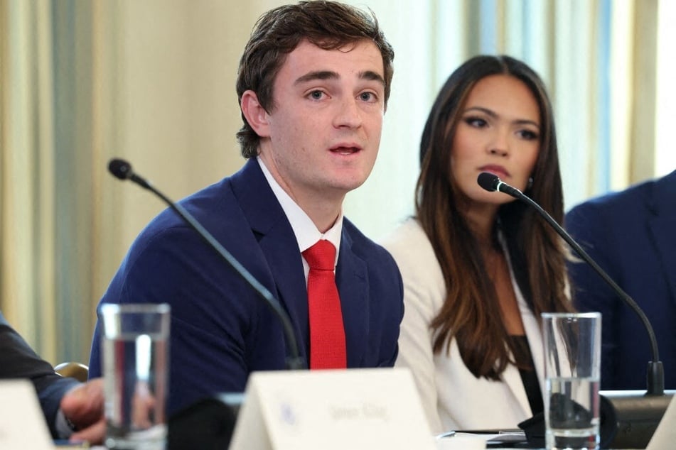 Nick Shirley (l) speaks during a roundtable discussion in the State Dining Room of the White House on October 8, 2025, in Washington, DC.