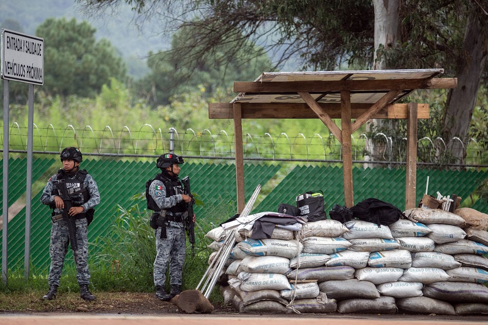 Armed Mexican National Guard members stand guard amid a deployment of 1500 troops to protect avocado farms in the country's Michoacan state.
