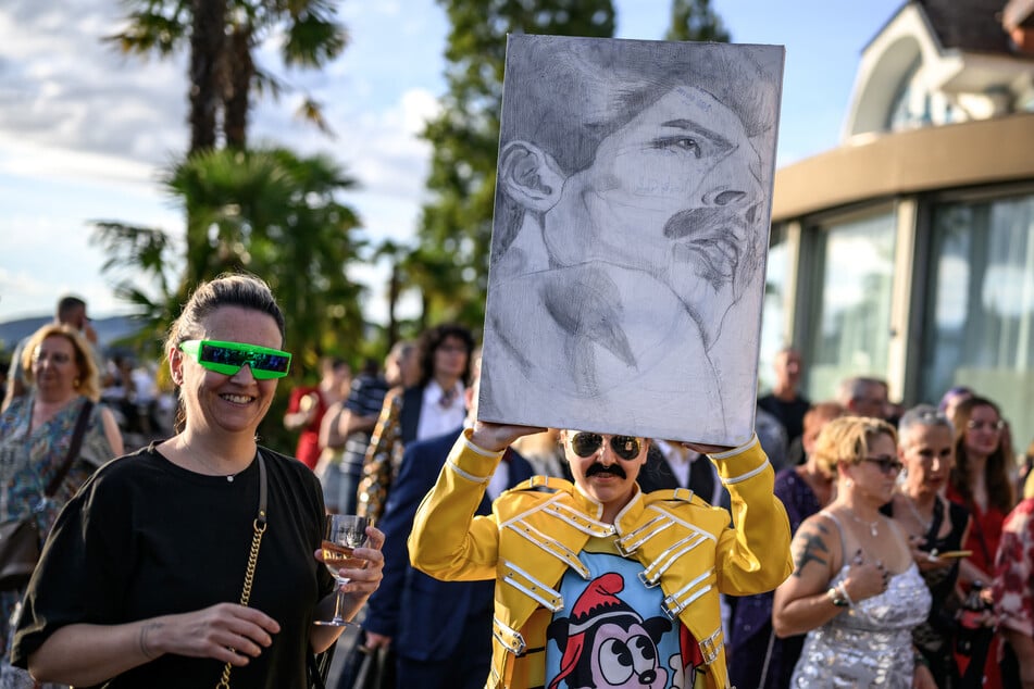 A fan holds a painting of Freddie Mercury during Montreux Freddie Day on September 5, 2026.