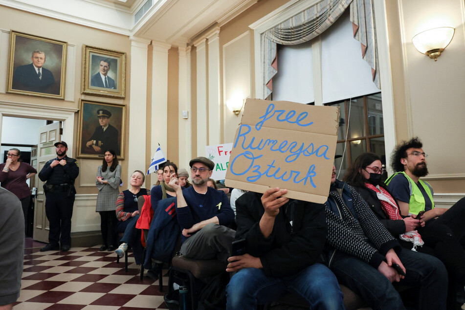 Demonstrators attend a city council meeting in Somerville, Massachusetts, on March 27, 2025, after Tufts University PhD student Rümeysa Öztürk was taken into custody by federal agents.