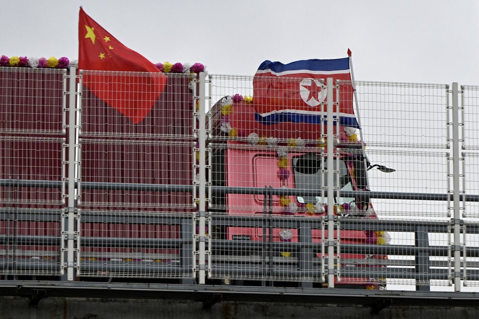 A truck bearing a North Korean flag crosses the new cross-border bridge linking it with China in Dandong, Liaoning Province, on October 15, 2026.