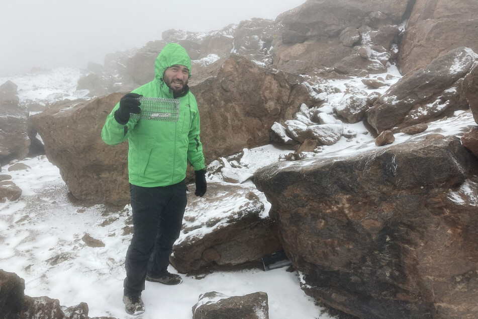 Jay Sortz an evolutionary biologist at the University of Nebraska, with a mouse trapped around the Aucanquilcha volcano in the Antofagasta Region of northern Chile.