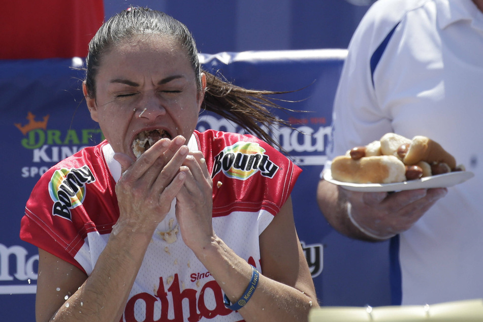 Michelle Lesco (37) downed 30 hotdogs to take the Mustard Belt for the women's division.
