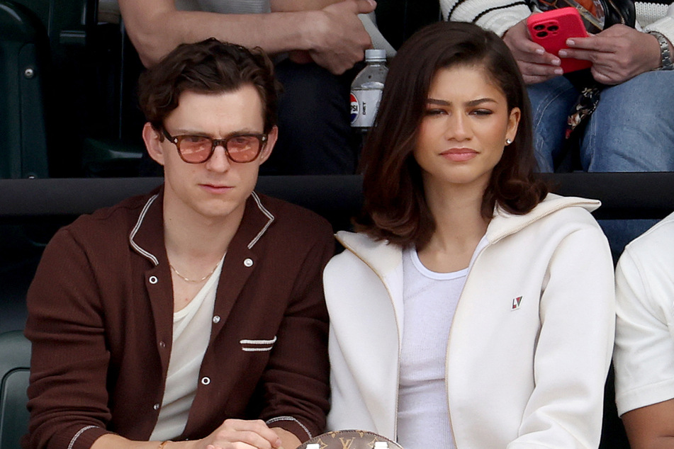 Zendaya (r.) praised Tom Holland's handling of fame as she admitted she has "complicated feelings" about kids and the spotlight.