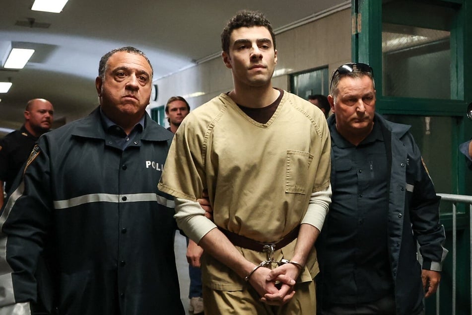 Luigi Mangione is seen being escorted by police as he arrives at court in New York City on September 16, 2025.