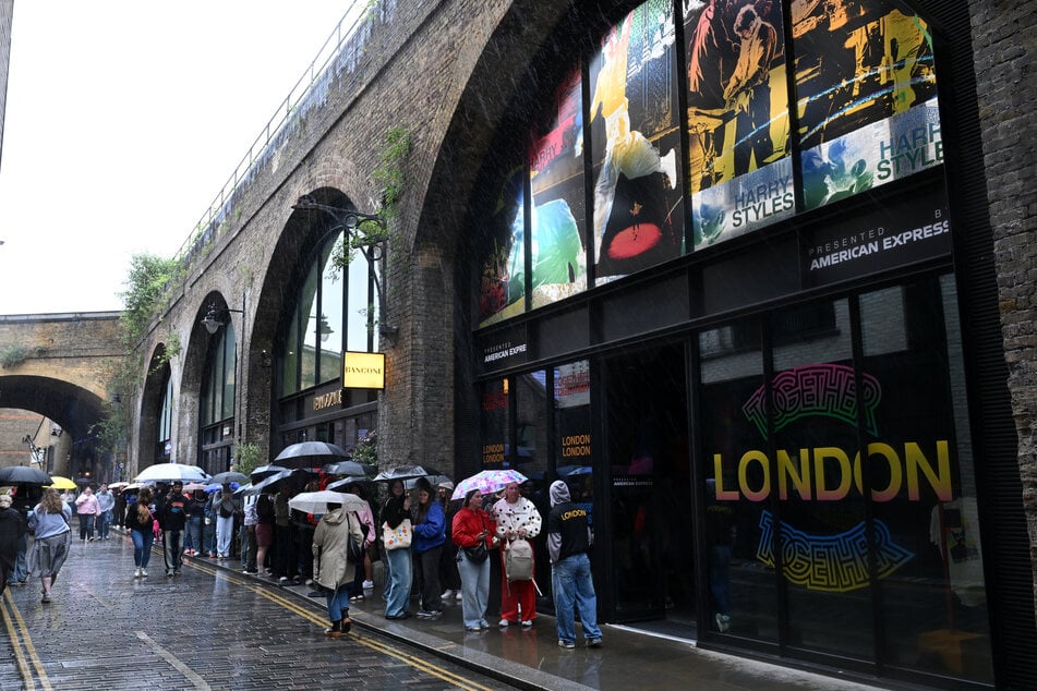Harry Styles fans line up to enter a pop-up store selling merchandise ahead of the UK leg of his Together, Together tour in east London on June 11, 2026.