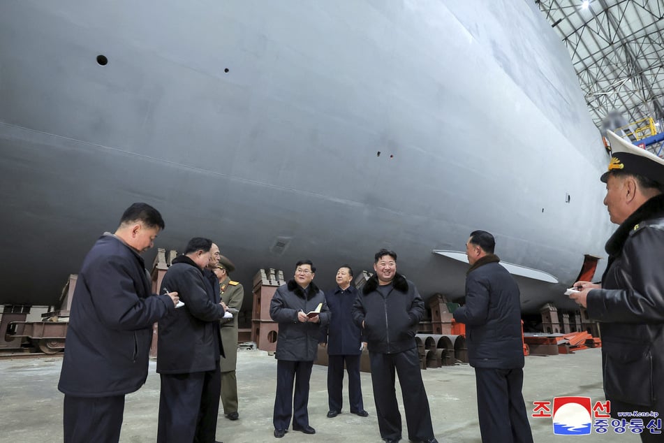 This undated picture released from North Korea's official Korean Central News Agency (KCNA) via KNS on Saturday shows North Korean leader Kim Jong Un (3rd R) inspecting a shipbuilding project at a major shipyard at an undisclosed location in North Korea.