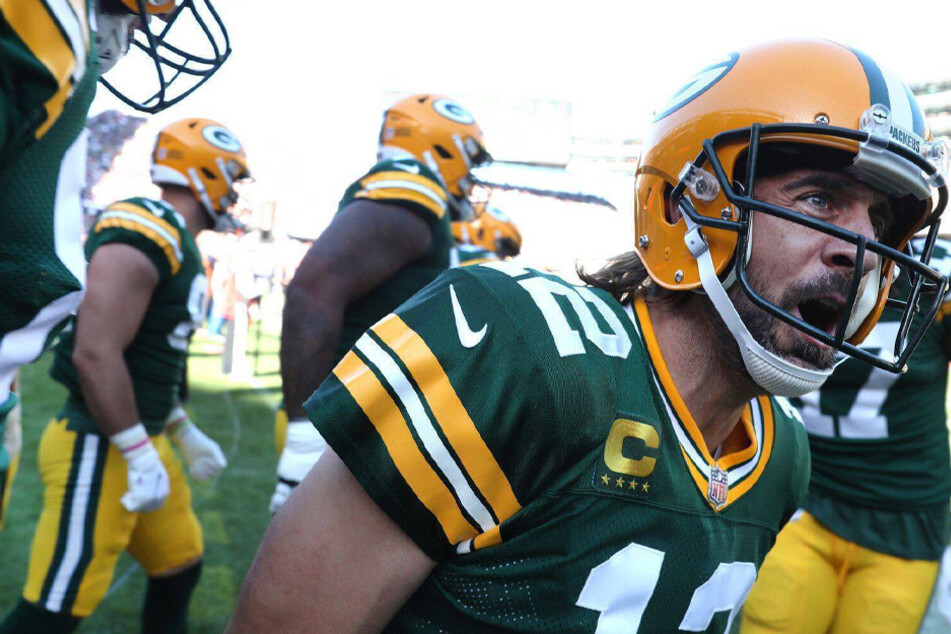 Aaron Rodgers celebrates after a rushing touchdown in a game against the Chicago Bears at Soldier Field on Sunday, October 17.