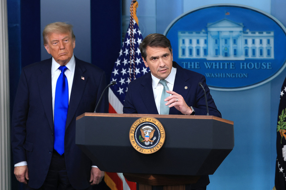 Then US Deputy Attorney General Todd Blanche (r.), joined by President Donald Trump, speaks at a press conference at the White House on June 27, 2025.