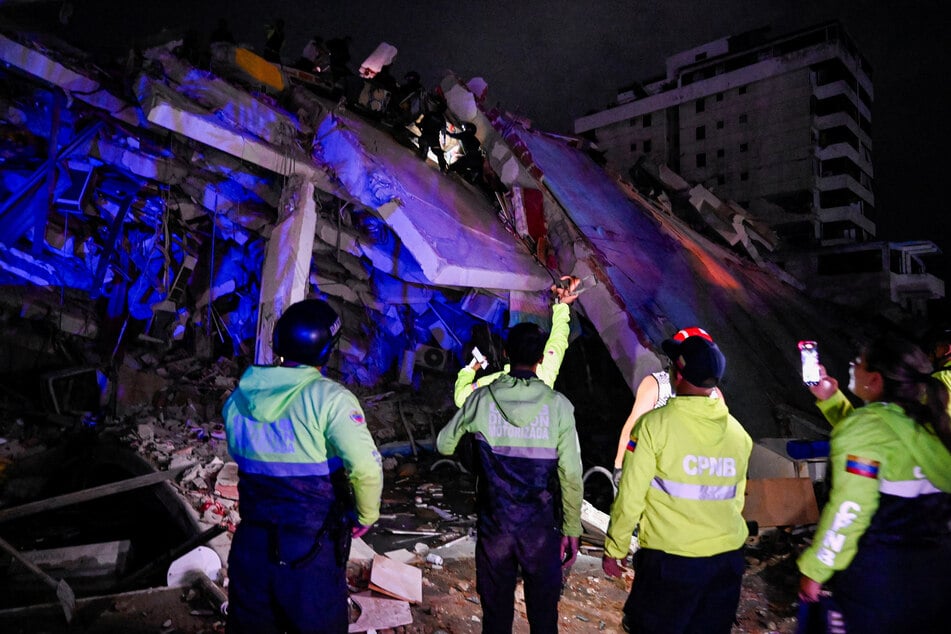 Emergency workers are pictured in front of a damaged building after an earthquake in La Guaira, Venezuela, on June 24, 2026.