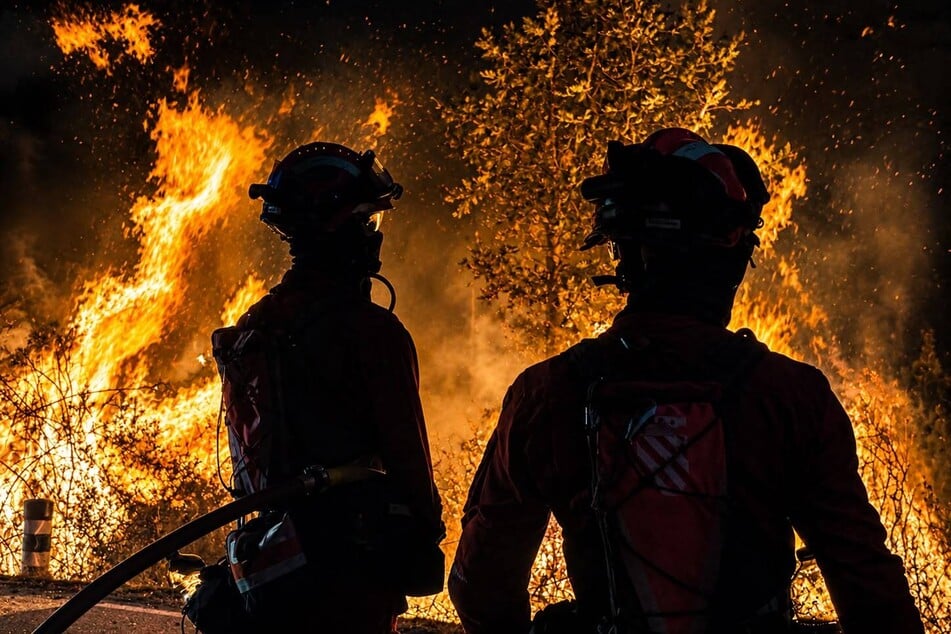 Spain's Military Emergencies Unit fight a wildfire in La Mierla, about 60 miles north of Madrid.