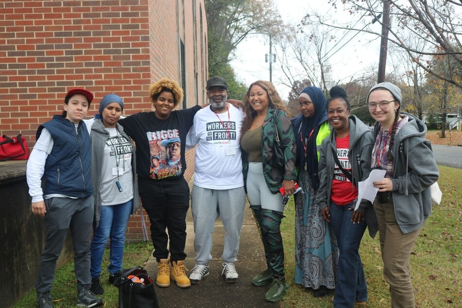 Wafae Said and her team smile together while knocking on doors in Columbus, Georgia.