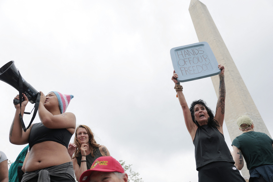 Protesters attend a "Hands Off" rally to demonstrate against President Donald Trump and his rightwing policies near the Washington Monument on the National Mall.
