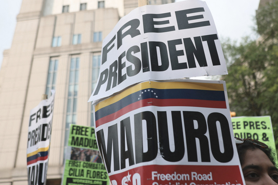 Protesters with signs reading "Free President Maduro" gathered outside the Manhattan courthouse waving Venezuelan flags on Wednesday.