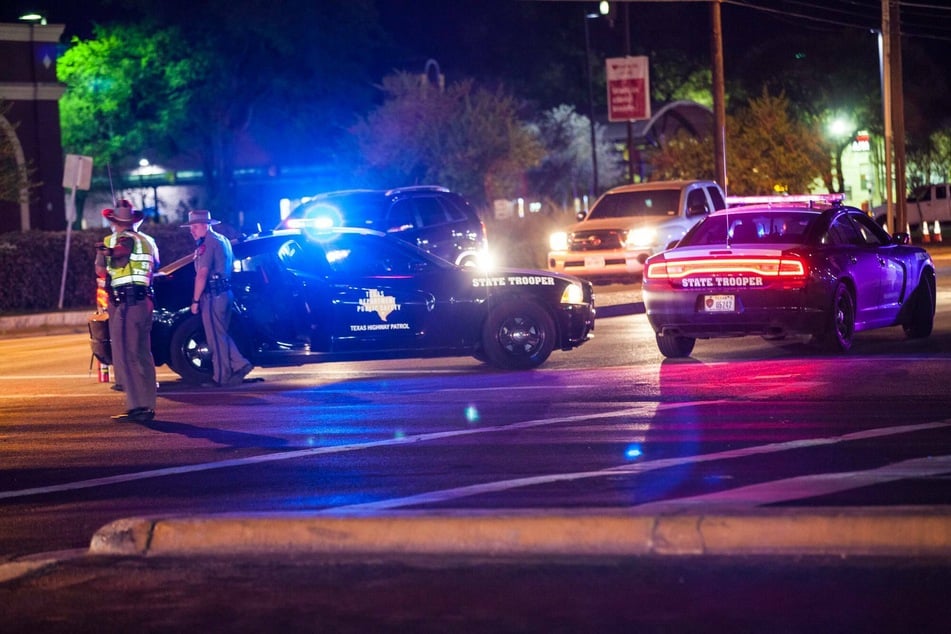 Law enforcement officials have dropped charges against the two original suspects as they search to arrest a third prime suspect.