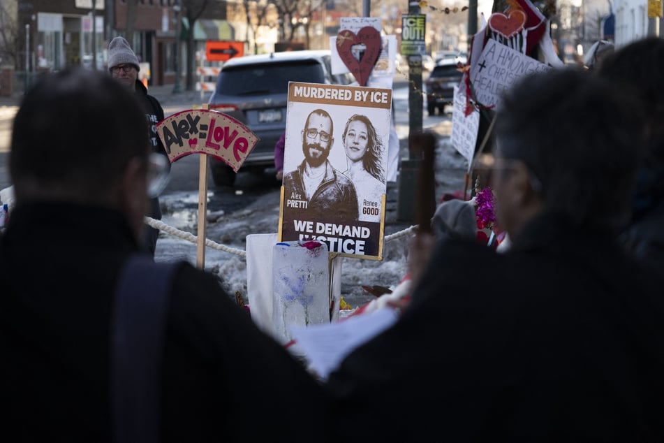 People gather at a memorial for Alex Pretti and Renee Good on February 12, 2026, in Minneapolis, Minnesota.