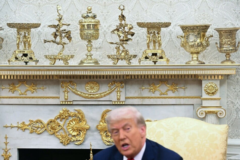 Gold colored ornaments and decor are seen as President Donald Trump speaks in the Oval Office of the White House in Washington, DC on September 25, 2025.
