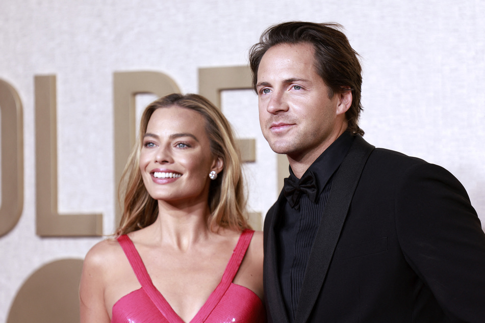 Barbie star Margot Robbie (l.) is reportedly expecting her first child with husband Tom Ackerly!