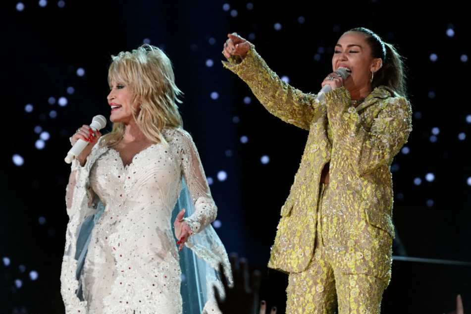 An elementary school teacher in Wisconsin named Melissa Tempel was fired for a tweet regarding the banning of a Miley Cyrus (r.) and Dolly Parton song about unity.