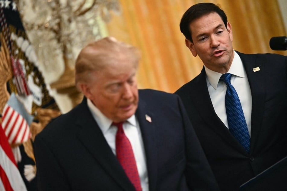 Secretary of State Marco Rubio (r.) speaks alongside President Donald Trump at an event. The US reportedly "kicked out" two Iranian delegates from the US, signaling Rubio "means business."