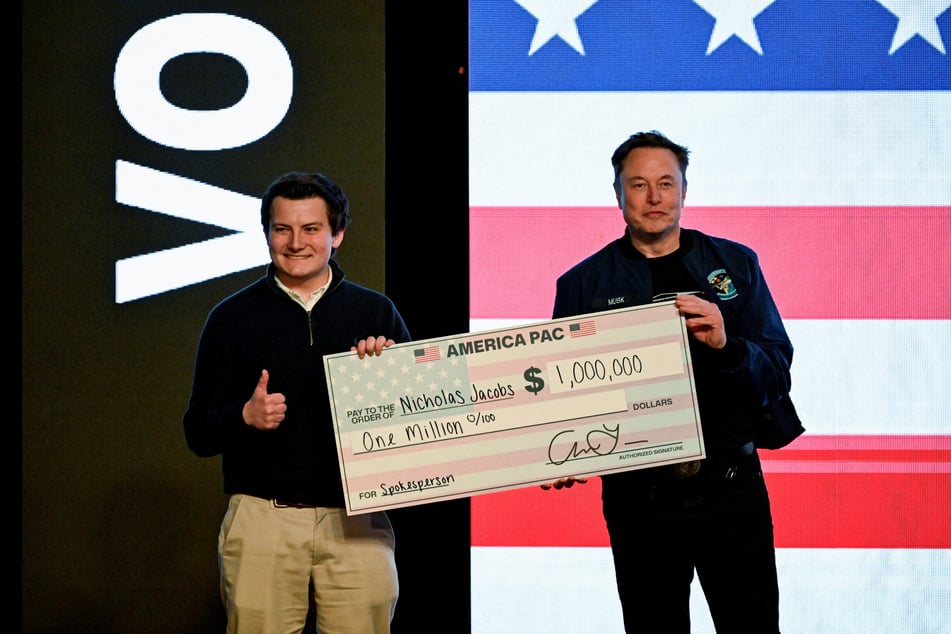 Musk presented two Wisconsin voters with $1-million checks each while on stage in Green Bay, Wisconsin.