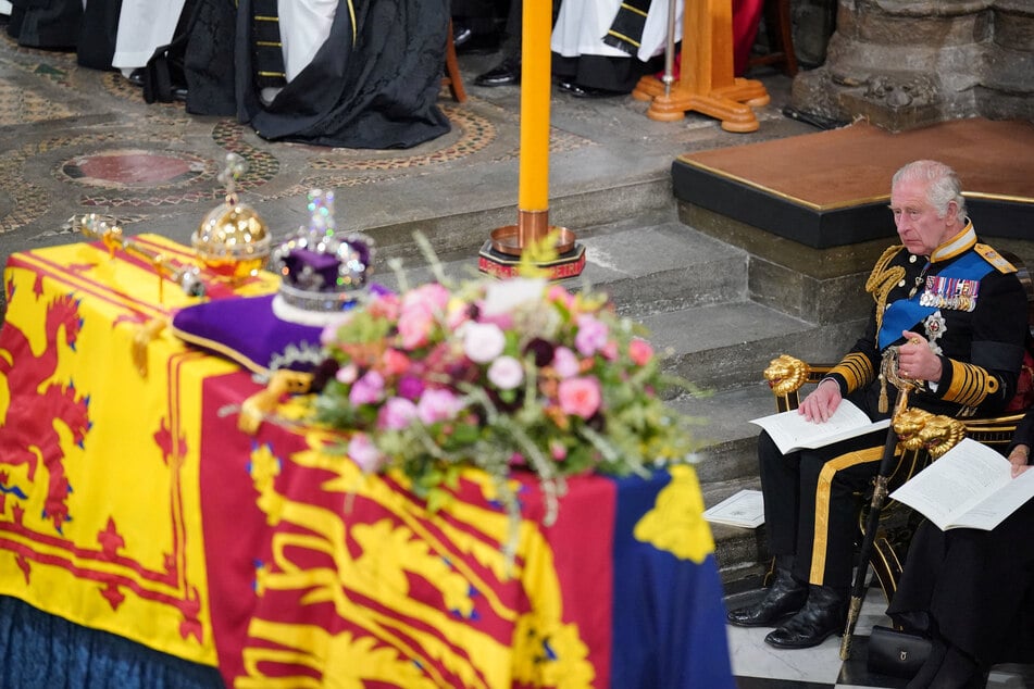 King Charles III in front of the coffin of Queen Elizabeth II during her State Funeral at Westminster Abbey in London.