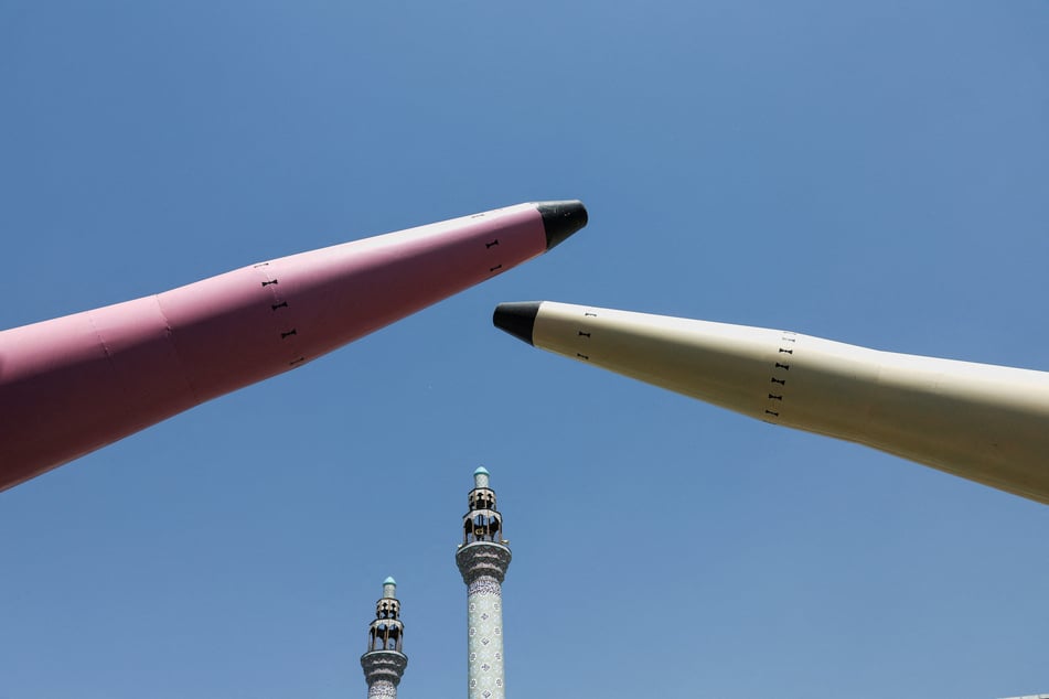 Symbolic mockups of Iranian missiles are displayed on a street in Tehran on June 11, 2026.
