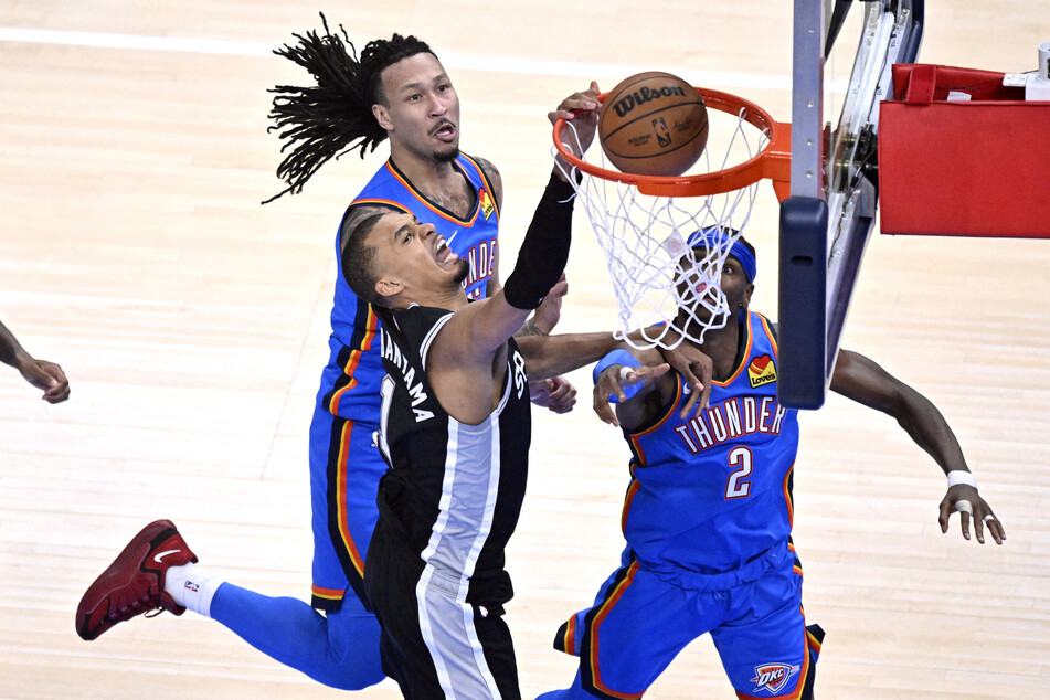 Victor Wembanyama shoots against Oklahoma City Thunder guard Shai Gilgeous-Alexander and forward Jaylin Williams in the third quarter during game seven of the Western Conference Finals.