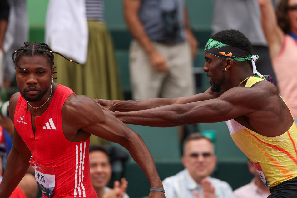 Noah Lyles is pushed by Kenny Bednarek following the Xfinity Men's 200m final during the 2025 USATF Outdoor Championships.