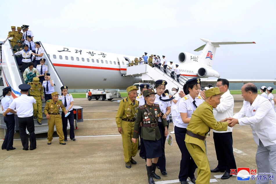 Participants attending the 70th anniversary commemorations of the Korean War armistice arrive in Pyongyang, North Korea.