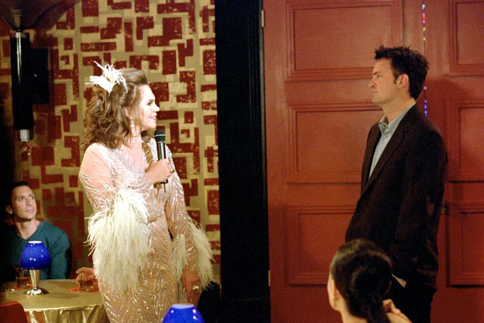 Chandler Bing, portrayed by Matthew Perry (r.) with his trans parent (l.) played by Kathleen Turner.