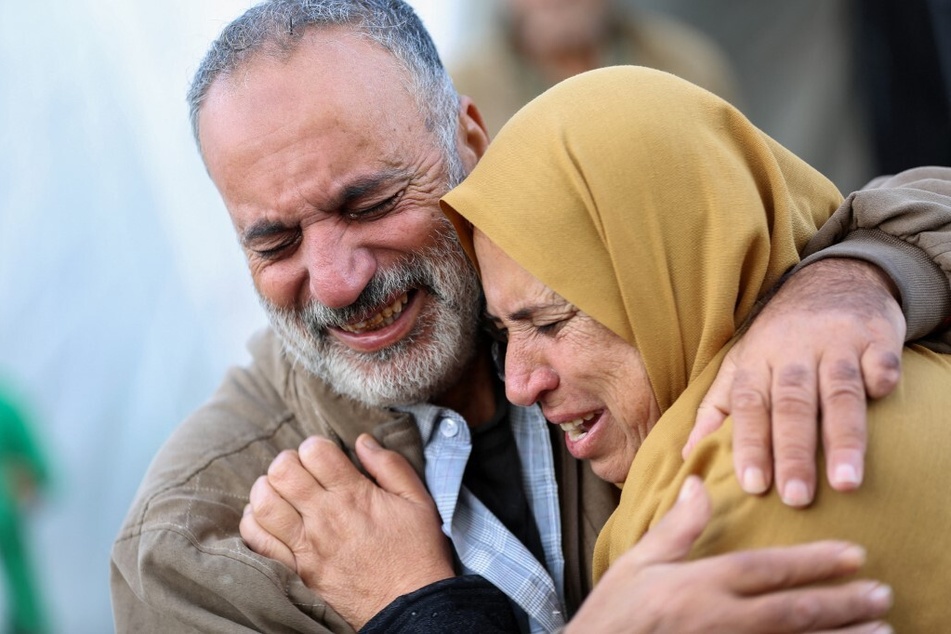 Palestinians react in a hospital yard as victims of Israeli bombardment are recovered, in Deir al-Balah in the central Gaza Strip.