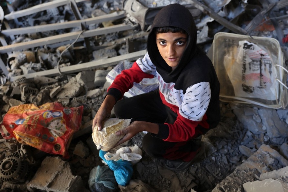A Palestinian child inspects the damage to the home of the Tabatibi family after Israeli bombardment in the Daraj neighborhood of Gaza on April 12, 2024.