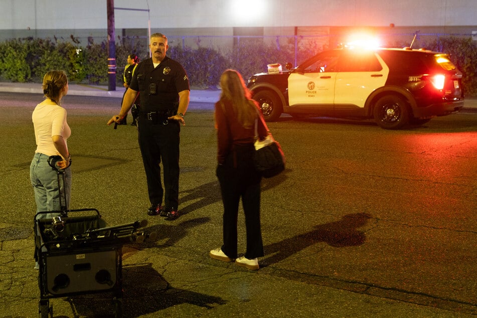 A Los Angeles police officer speaks with reporters near the scene after a news helicopter crashed in Chatsworth on September 15, 2026.