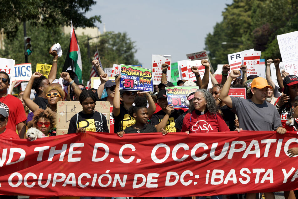 Demonstrators take part in the "We Are All DC" national march calling for an end to the deployment of National Guard troops in Washington DC on September 6, 2025.