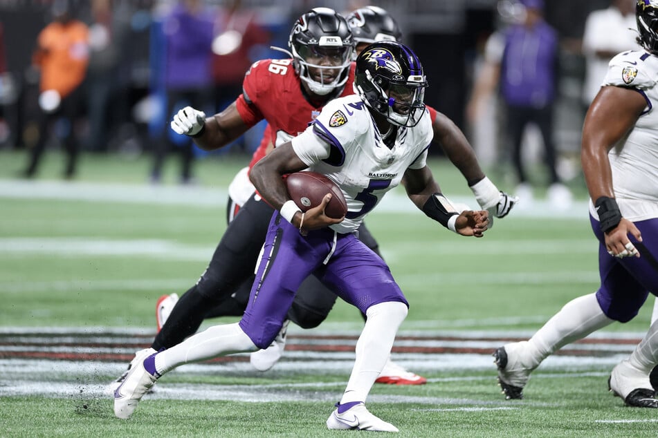 Tyler Huntley of the Baltimore Ravens runs the ball against the Atlanta Falcons in overtime of their game at Mercedes-Benz Stadium.