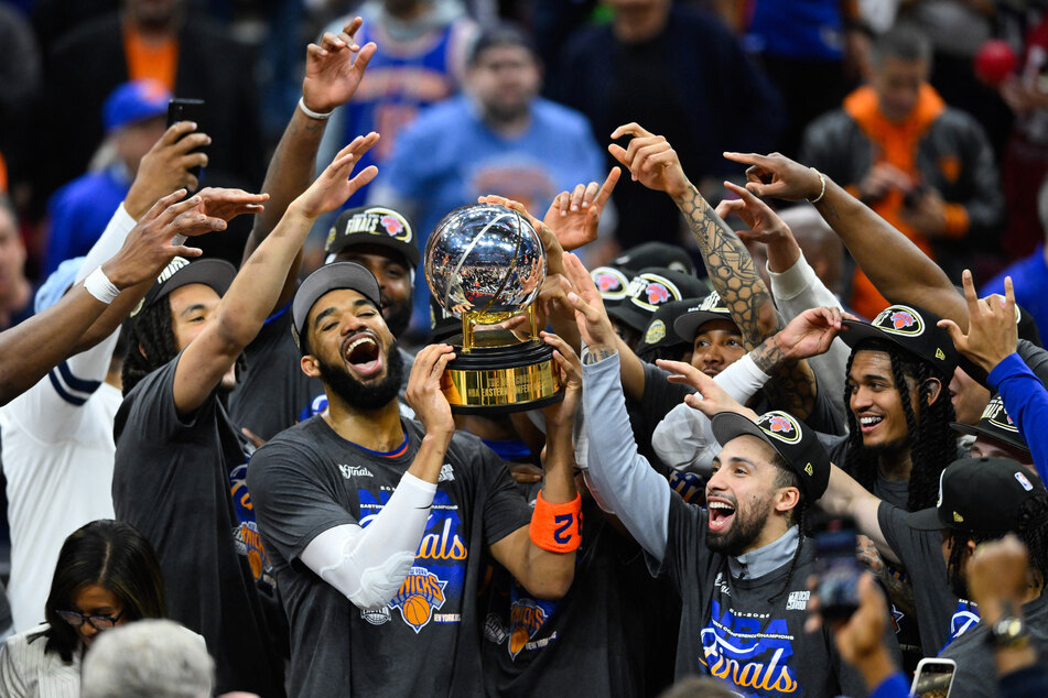 New York Knicks center Karl-Anthony Towns lifts the 2026 Eastern Conference trophy with his teammates after defeating the Cleveland Cavaliers in game four of the eastern conference finals for the 2026 NBA playoffs at Rocket Arena.