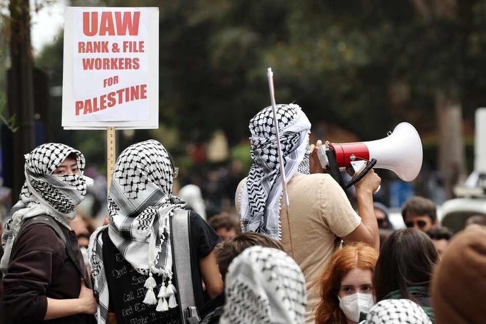 Gaza solidarity protestors rally with a sign reading "UAW Rank & File Workers For Palestine" after police cleared an encampment on the University of California, Los Angeles campus in May 2024.
