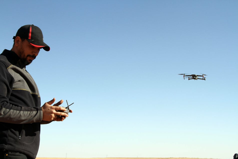 A man prepares a drone to take photos of the desert during a large desert tourism event in Shwayrif, a village southwest of Libya's capital Tripoli.