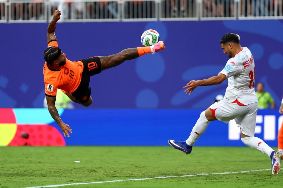 Netherlands' Memphis Depay in action with Tunisia's Hadj Mahmoud in their World Cup Group F match on June 25, 2026.