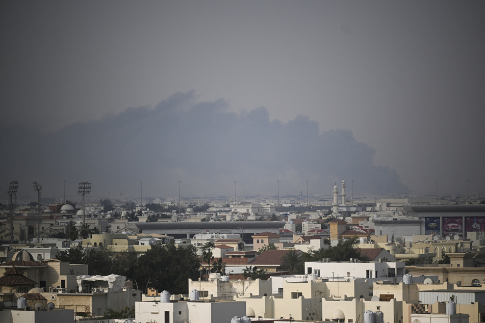 A plume of smoke rises following a reported Iranian strike in Doha on March 1, 2026.